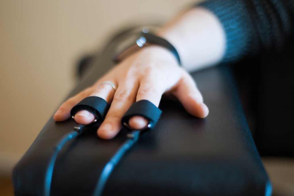 “Polygraph machine bands attached to fingers, representing professional polygraph services, credibility verification, and forensic assessment solutions.”
